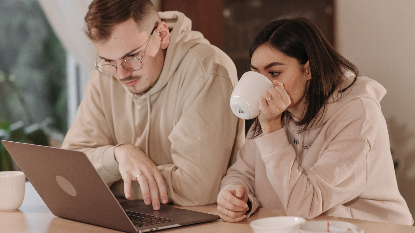 Couple reviewing mortgage and household finances on a laptop at home